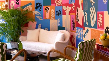 a living room with a bold colorful wallpaper
