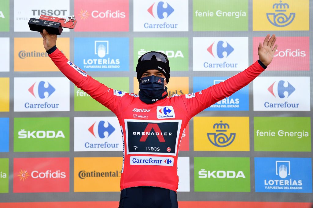 ALTODELANGLIRU SPAIN NOVEMBER 01 Podium Richard Carapaz of Ecuador and Team INEOS Grenadiers Red Leader Jersey Celebration Trophy Mask Covid safety measures during the 75th Tour of Spain 2020 Stage 12 a 1094km stage from Pola de Laviana to Alto de lAngliru 1560m lavuelta LaVuelta20 La Vuelta on November 01 2020 in Alto de lAngliru Spain Photo by Justin SetterfieldGetty Images