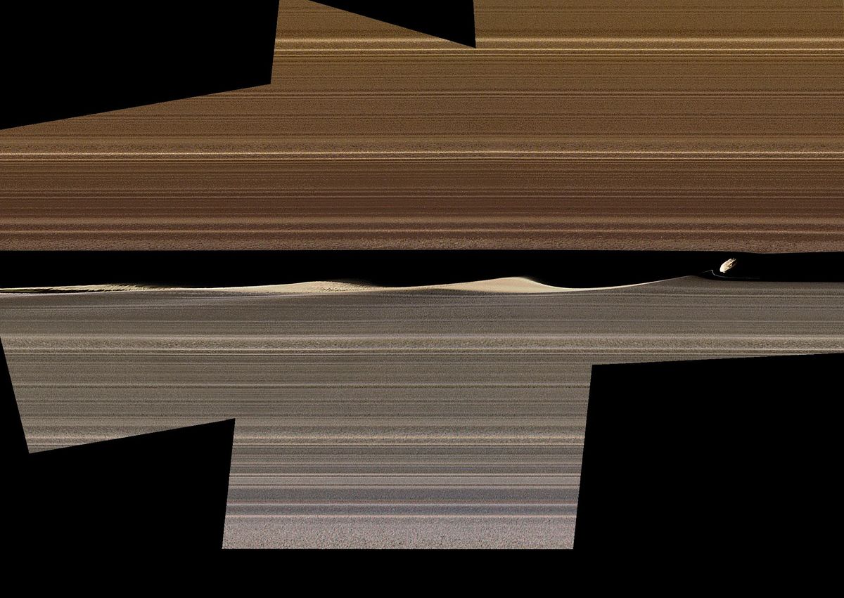 An enhanced-color image shows waves in the rings of Saturn caused by the small moon Daphnis.