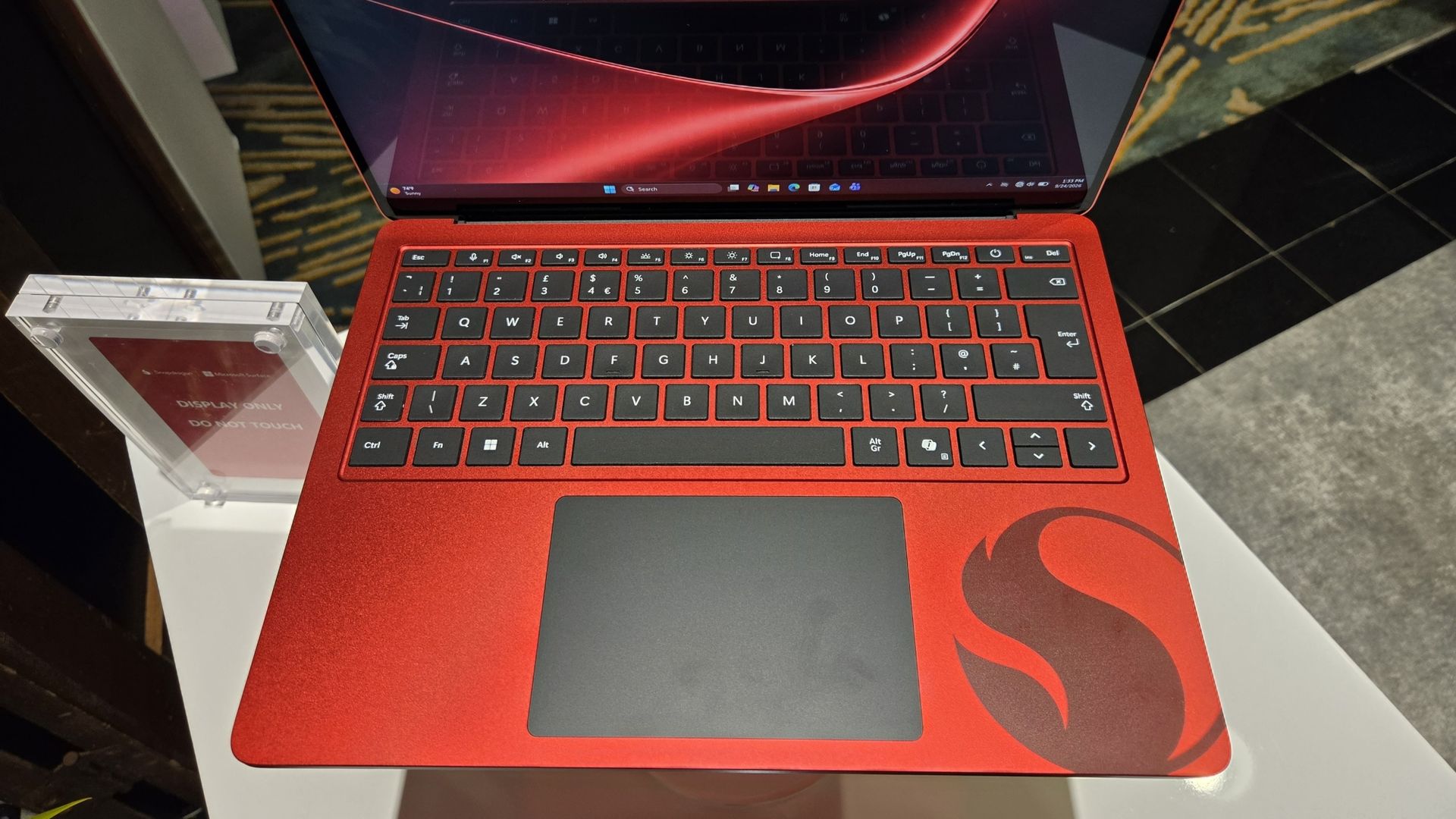 Microsoft Surface Laptop 13-inch 2nd Edition with Manchester United and Qualcomm Snapdragon branding on a red chassis, displayed with football imagery