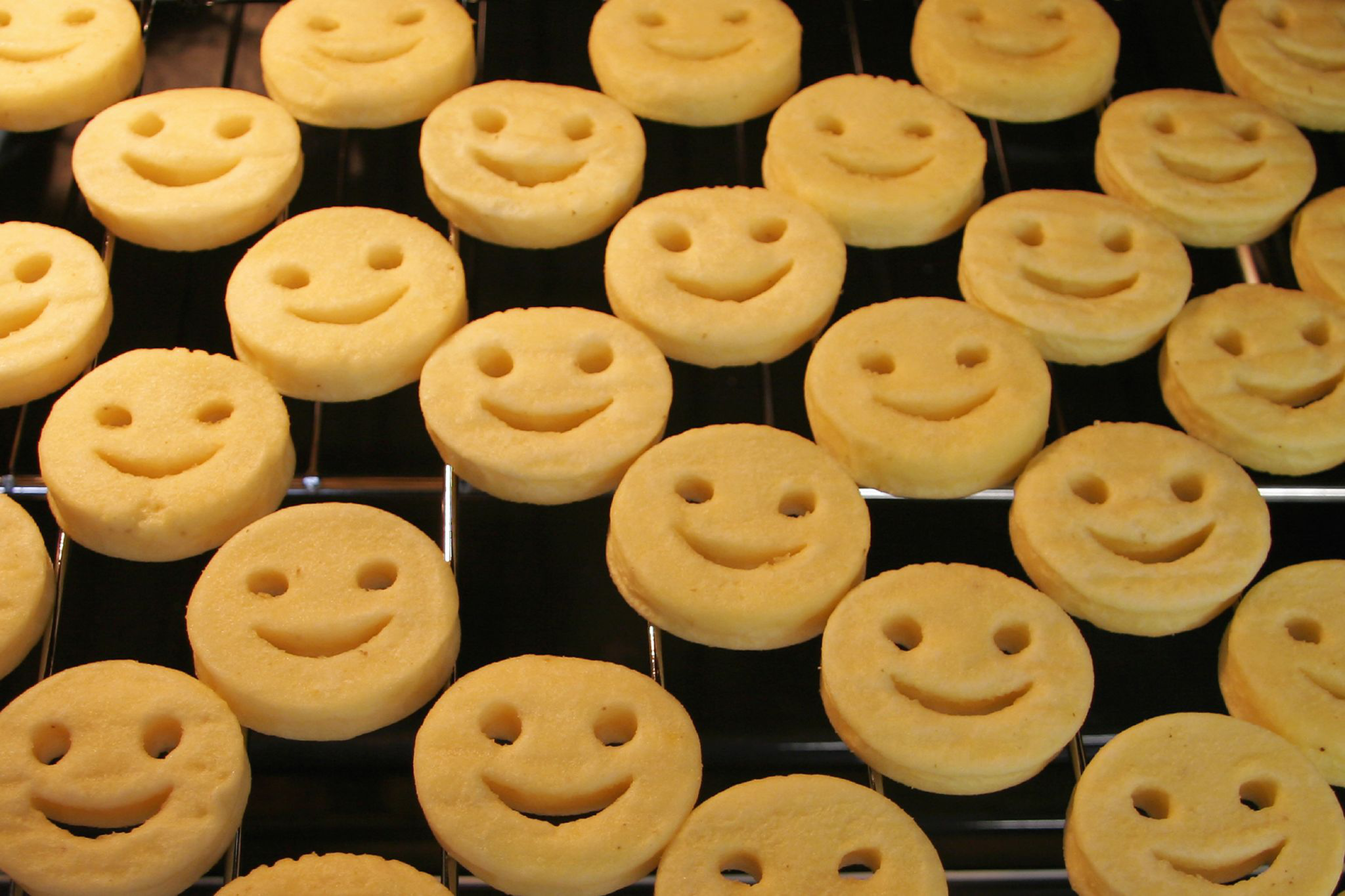 A close up of potato smiles on a baking tray