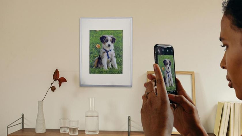 A person changing the photo on a digital frame