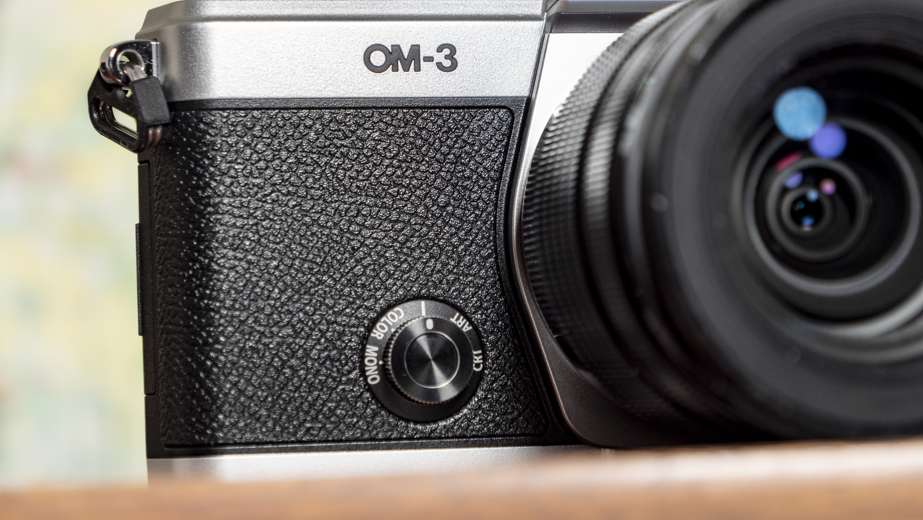 The color mode dial of the OM System OM-3 mirrorless camera