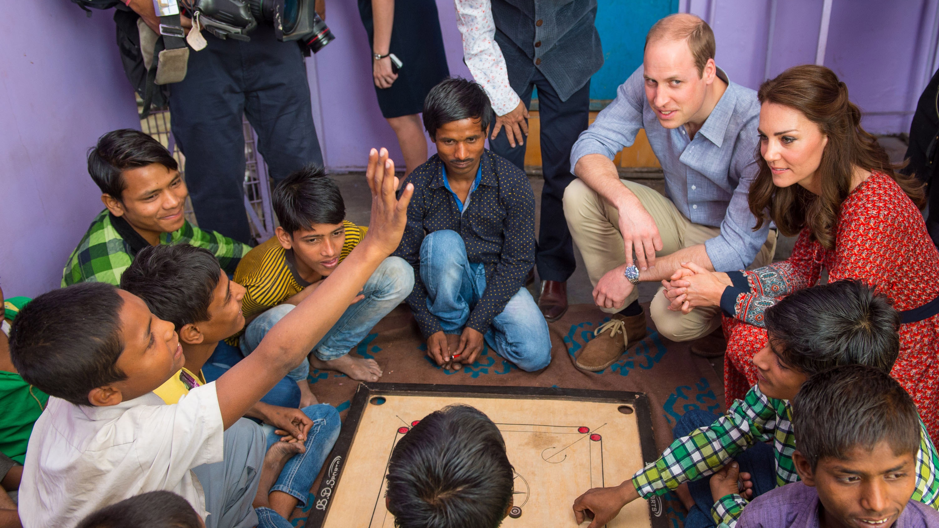 Catherine, Princess of Wales and Prince William play a game of carrom with children at a contact centre run by the charity Salaam Baalak on April 12, 2016