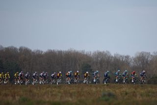 The pack of riders cycles during the 1st stage of the Paris-Nice cycling race, 156,1 km between Le Perray-en-Yvelines and Le Perray-en-Yvelines, on March 9, 2025. (Photo by Anne-Christine POUJOULAT / AFP)