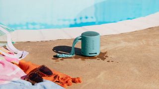 Sony SRS-XB100 Bluetooth speaker in blue by the pool