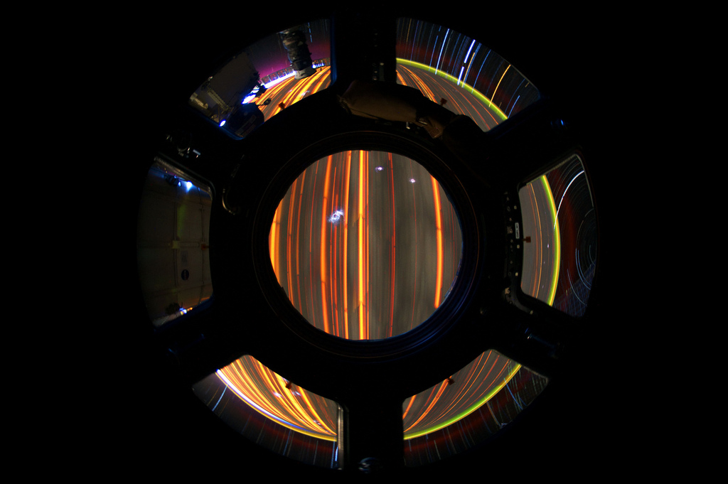 a view of light streaks out a space station window
