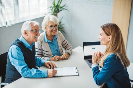 Couple consulting with female advisor