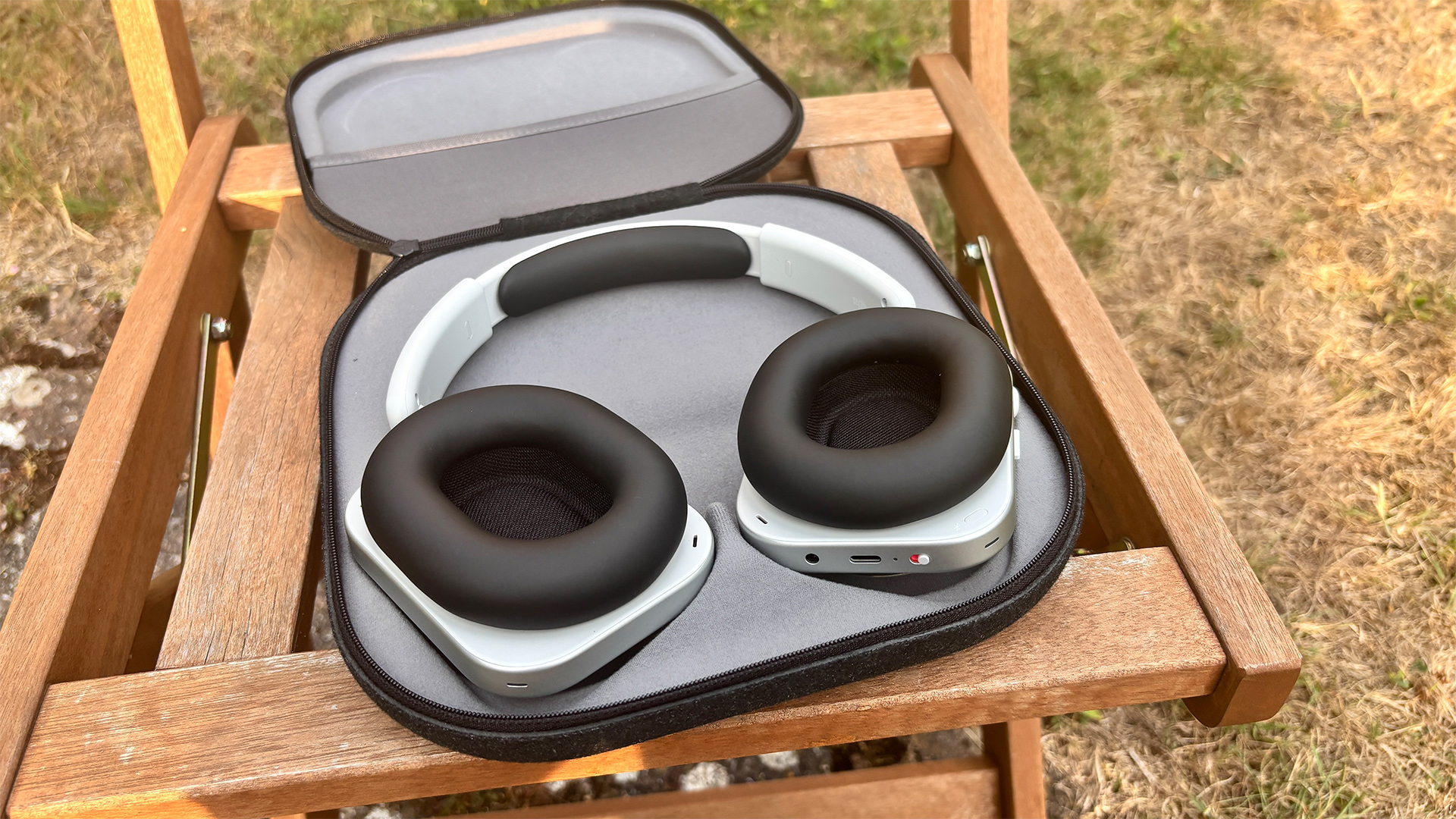 Nothing Headphone (1) wireless headphones in case on wooden garden chair