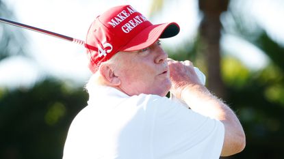 Donald Trump take sa shot during the pro-am before the 2022 LIV Golf Team Championship in Florida