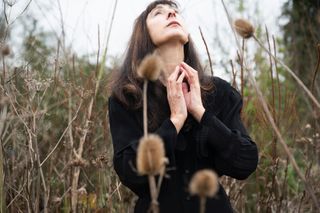 a press shot of movement coach marie-gabrielle roti in a field