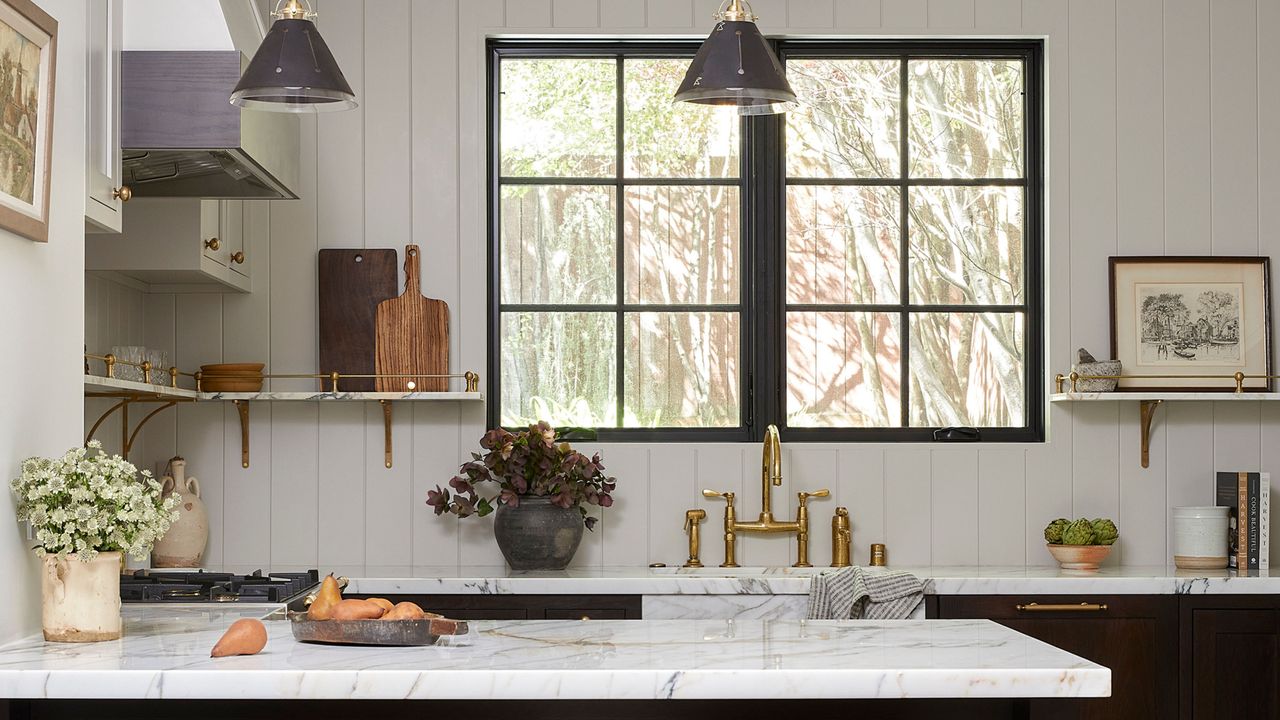 White kitchen with marble top and dark cabinets