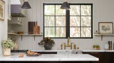 White kitchen with marble top and dark cabinets