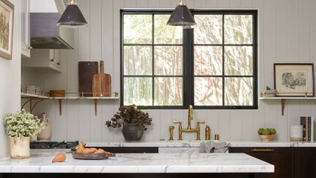 White kitchen with marble top and dark cabinets