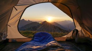 View of sunrise from inside a tent