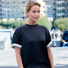 Jennifer Lawrence attended a film festival in spain wearing a T-shirt, pants, and a dress-like train