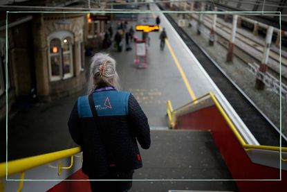 A rail worker in an Avanti West Coast uniform walking onto a train platform