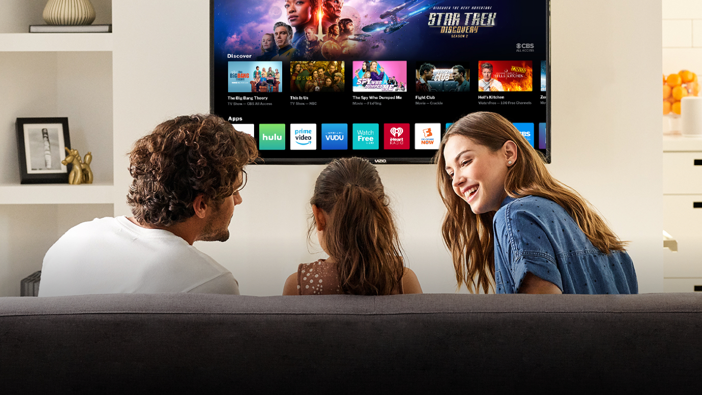 40-inch TV hangs on wall as family watches on sofa