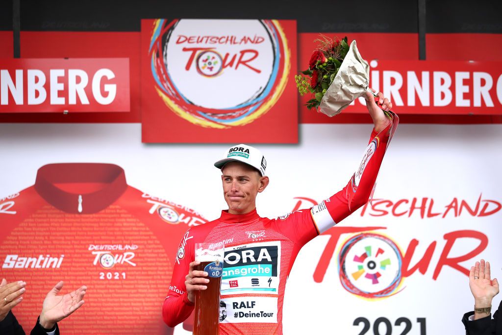 NUREMBERG GERMANY AUGUST 29 Nils Politt of Germany and Team Bora Hansgrohe celebrates winning the red leader jersey on the podium ceremony after the 35th Deutschland Tour 2021 Stage 4 a 1563km stage fro Erlangen to Nrnberg DeineTour on August 29 2021 in Nuremberg Germany Photo by Christian KasparBartkeGetty Images