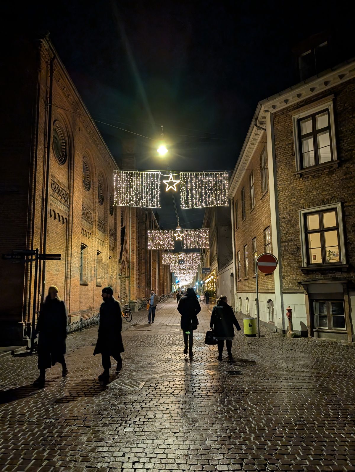 A street at night lit with Christmas lights