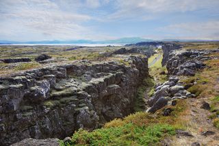 A rare view of the divide between two continental plates is visible at Thingvellir National Park in Iceland. This chasm divides the Eurasian continent from the North American continent.