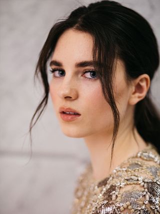 Portrait of actress Darci Shaw wearing a beaded top.