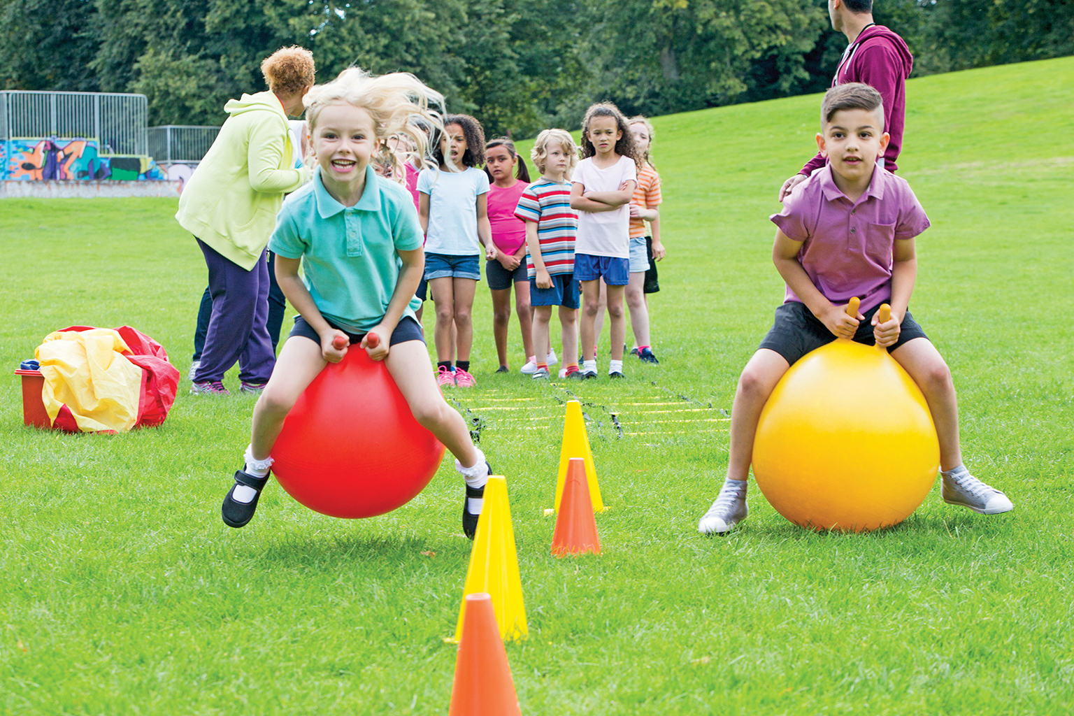 Young children in a sports day space hopper race.