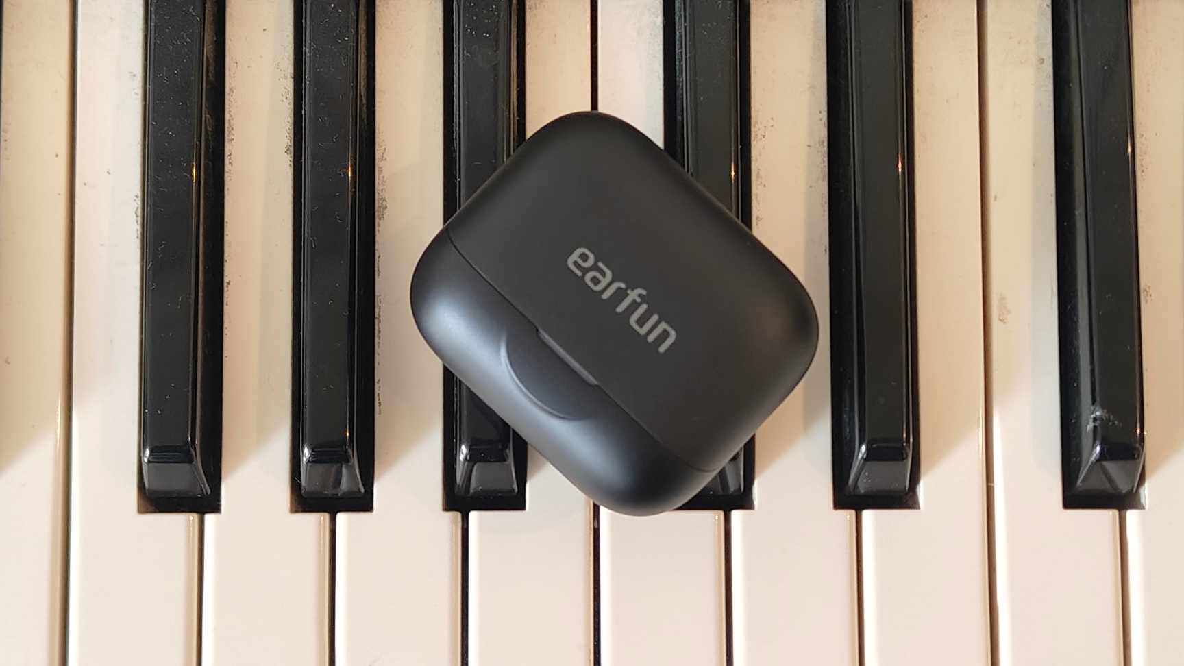 The Earfun Air Pro 4 Plus on top of a keyboard.