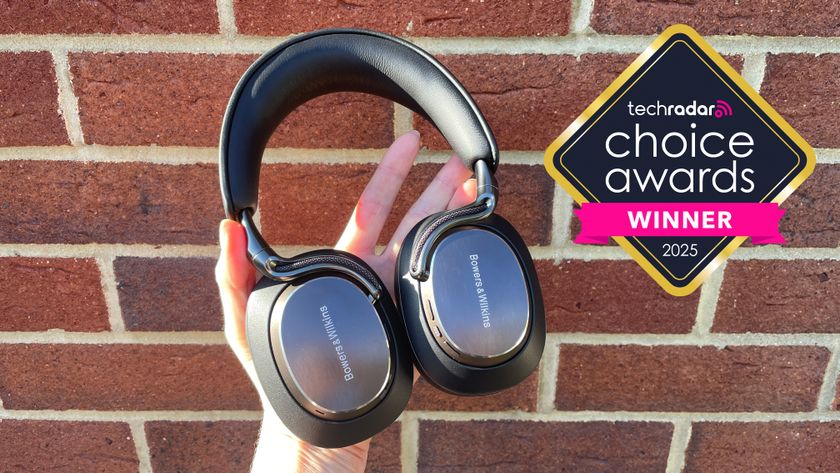 Bowers &amp; Wilkins Px8 S2 headphones held in a woman&#039;s hands, with a logo saying TechRadar Choice Awards Winner 2025