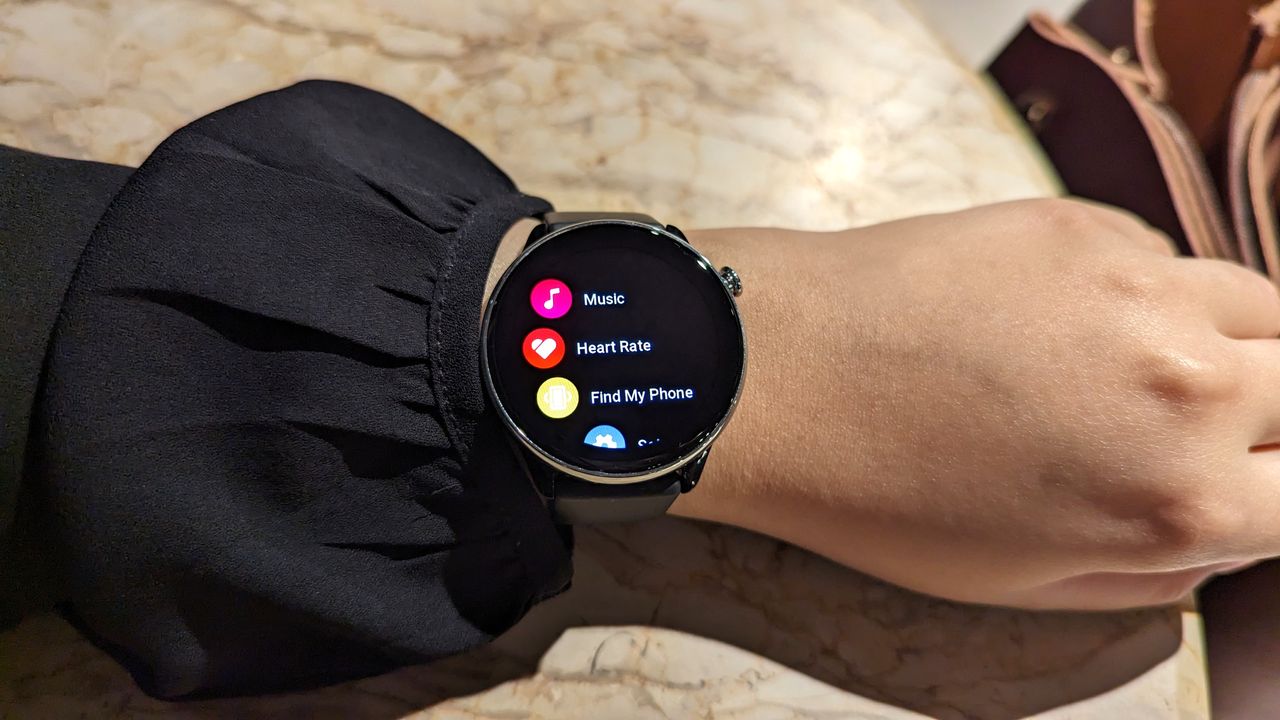 Amazfit GTR Mini smartwatch worn on a wrist, showcasing the UI.