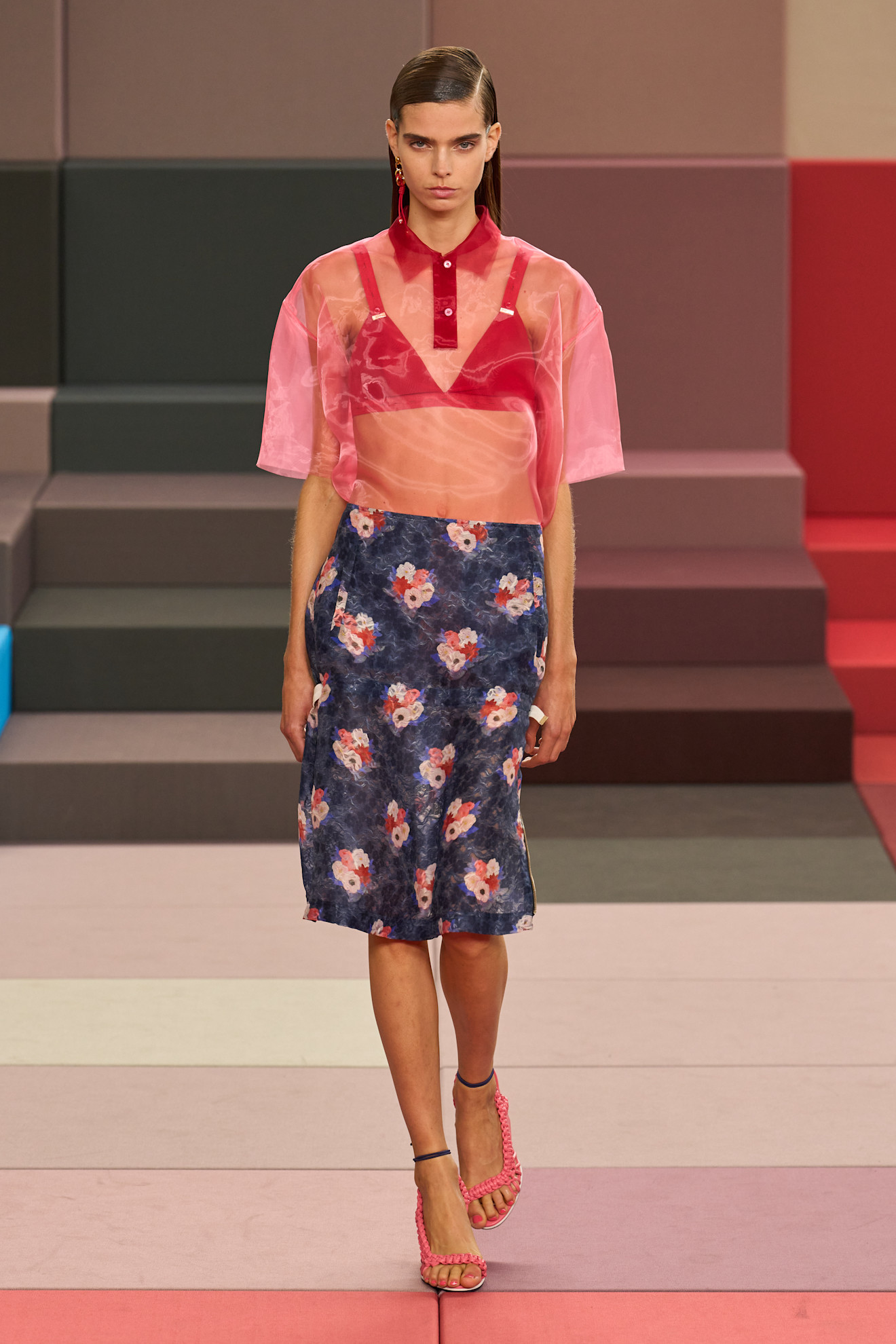 Spring/summer 2026 runway model in a pink sheer skirt and floral skirt.
