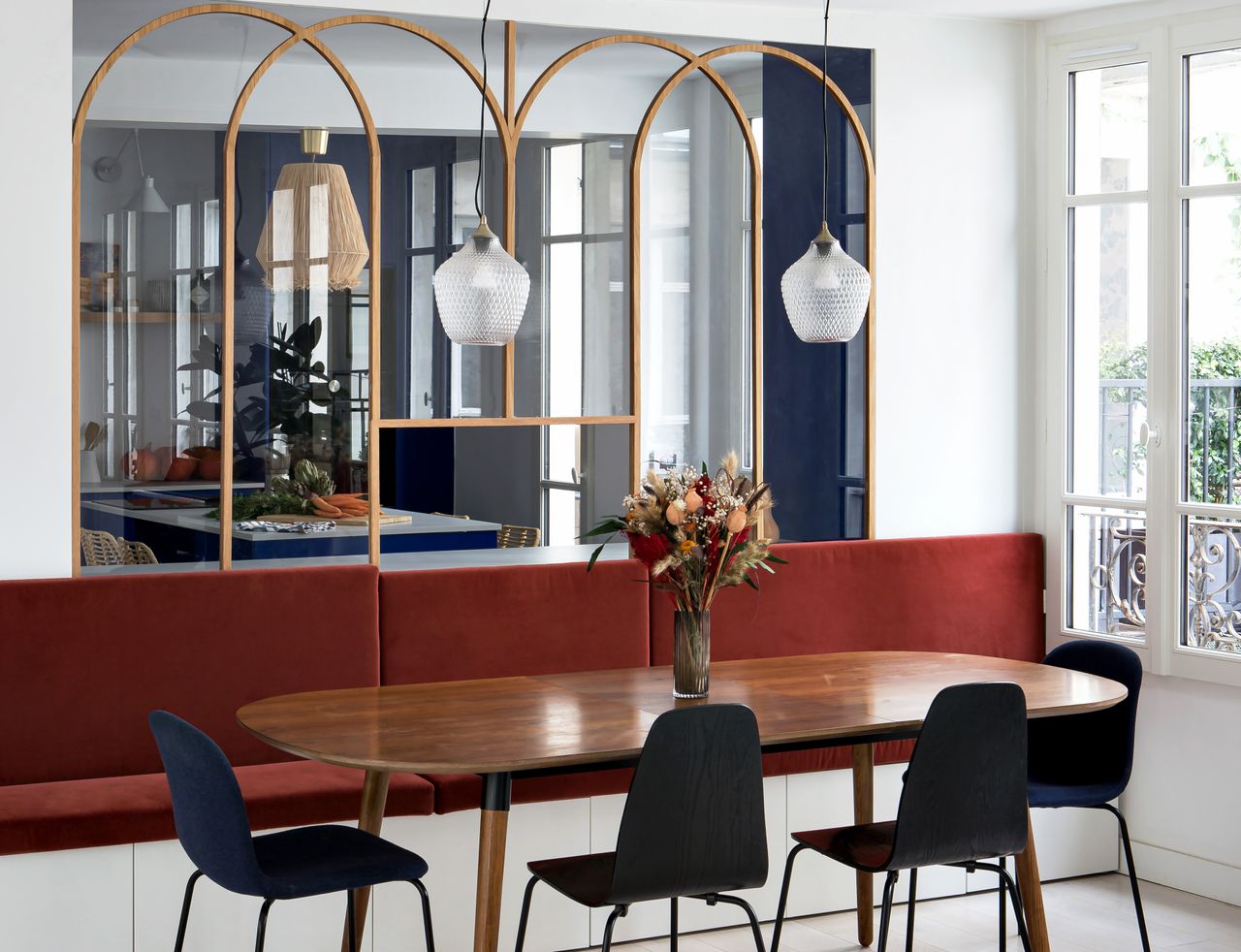 A dining room with maroon seats and blue chairs