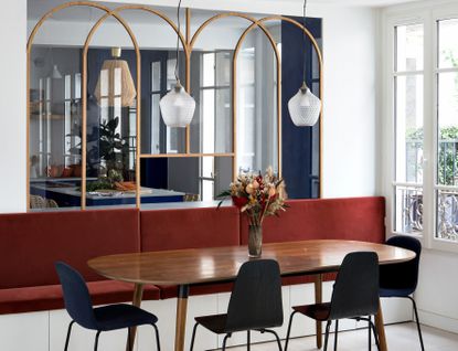 A dining room with maroon seats and blue chairs