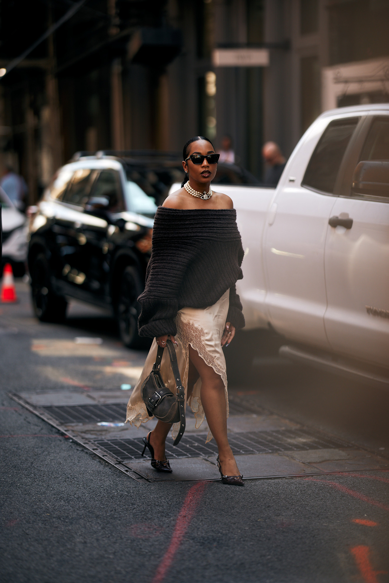 woman wearing a sweater, silk skirt, and pumps