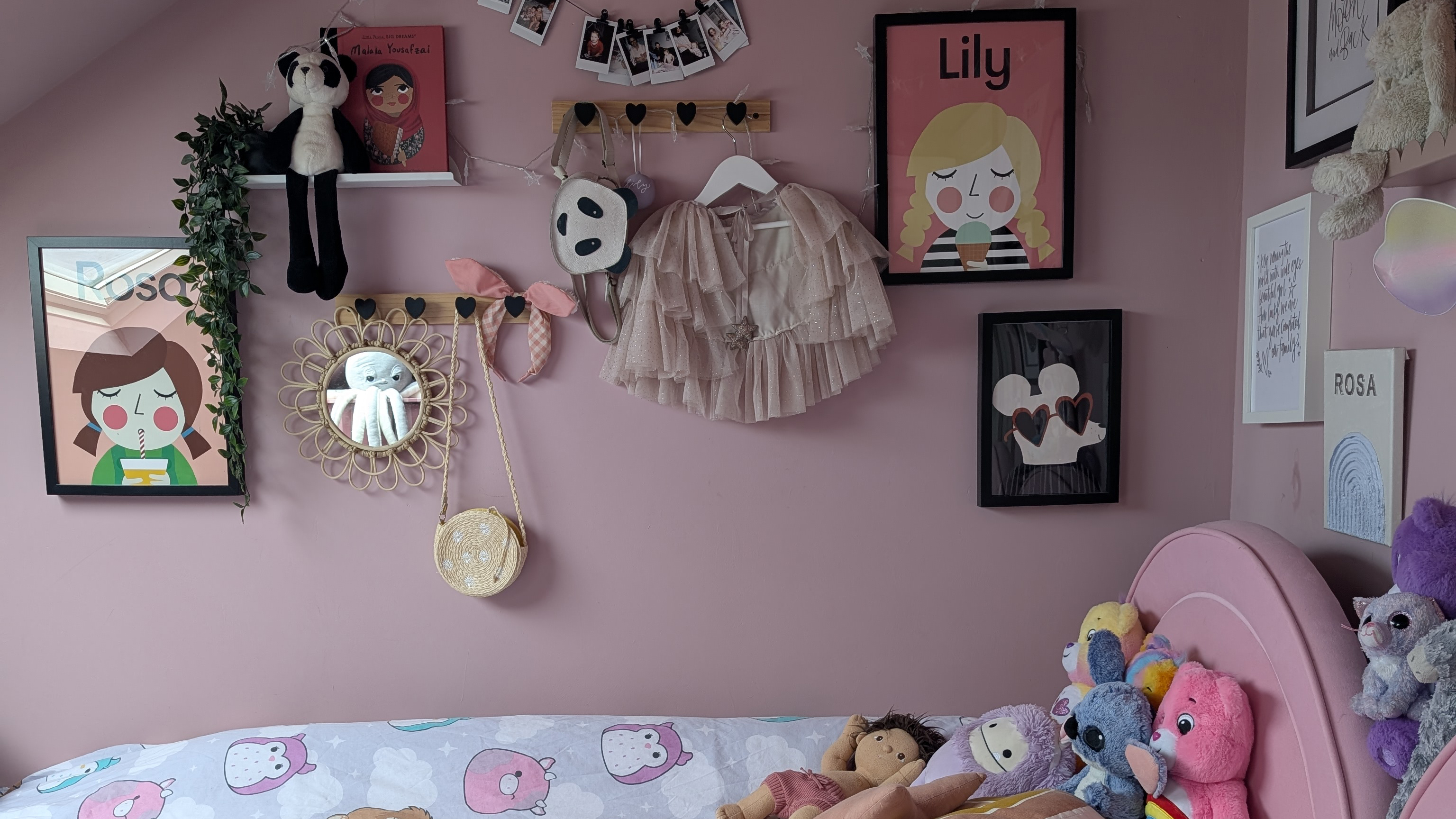 pink girls bedroom with gallery wall of framed prints
