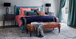 dark grey bedroom with matching bedside tables and patterned bedding