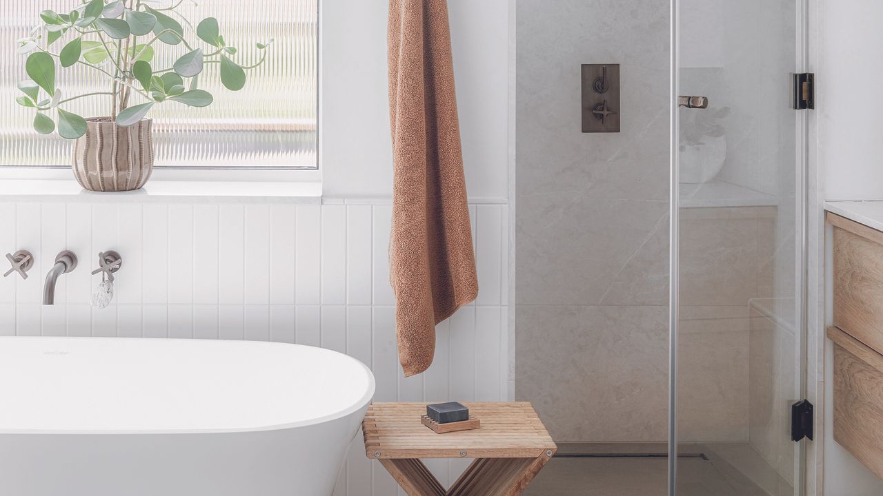 White bathroom with enclosed glass shower room