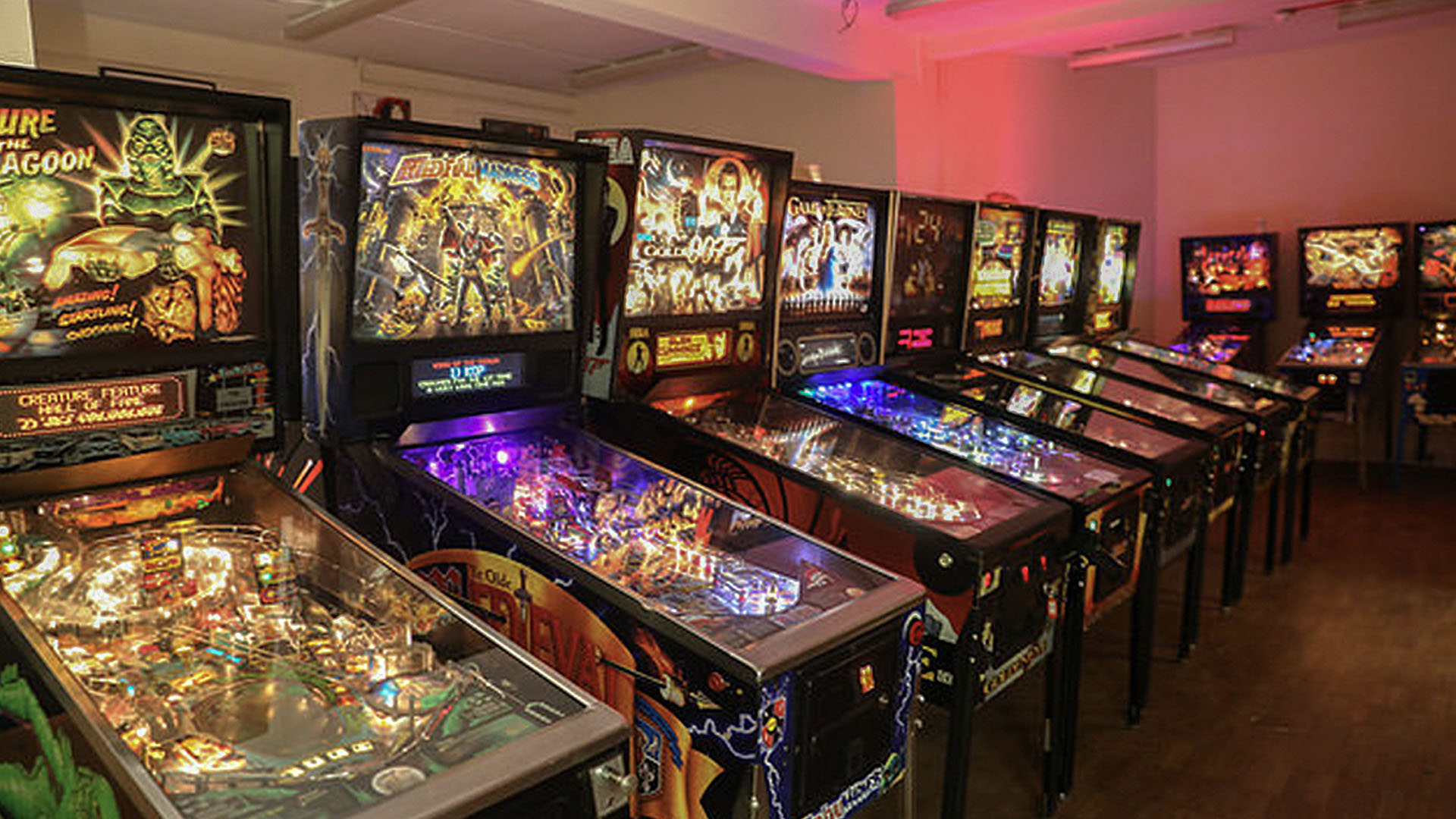 A photo of series of pinball machines.