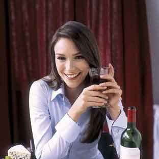 model eating steak cheese chocolate wine and bread at restaurant