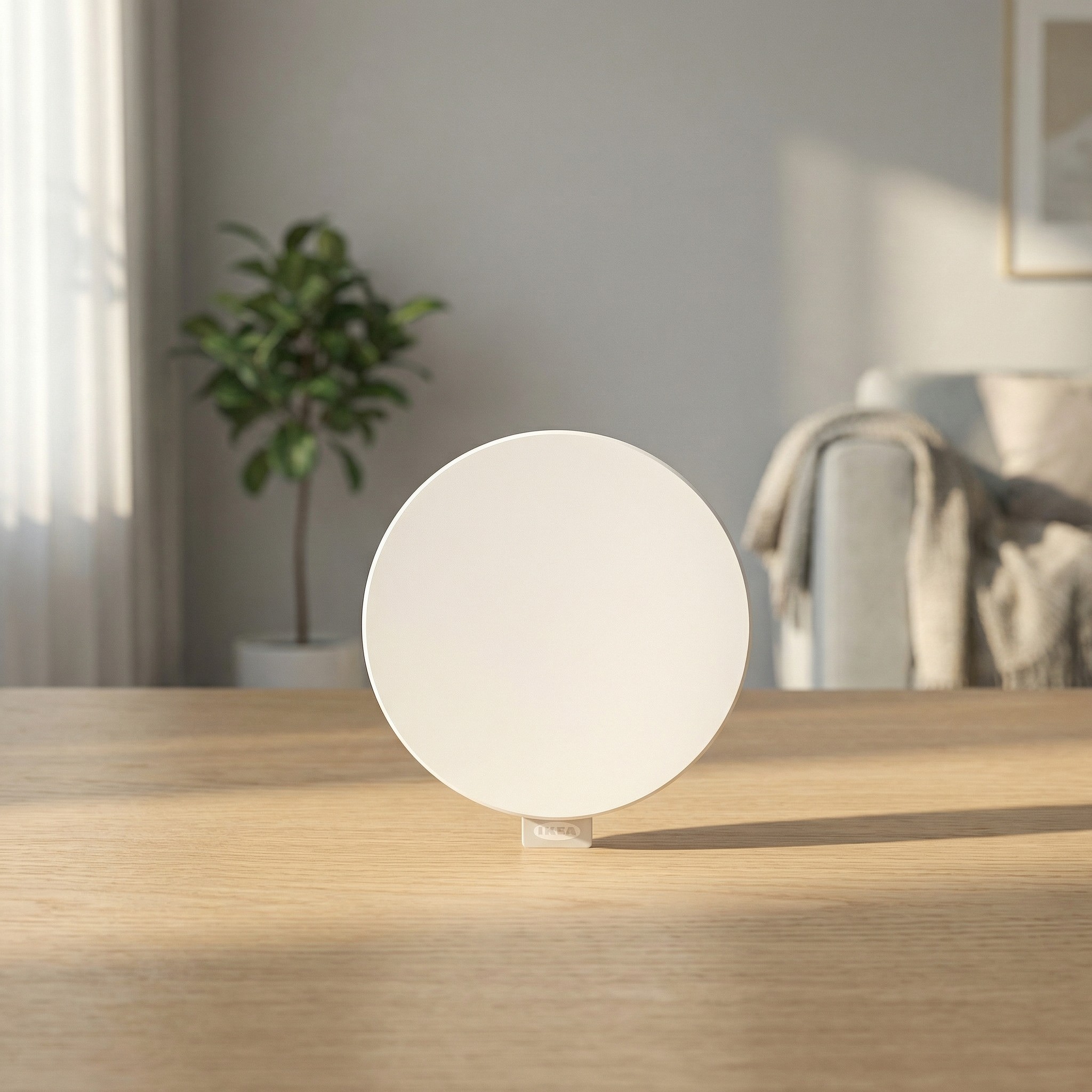 IKEA Dirigera Hub, one of the best smart hubs, on a wooden surface