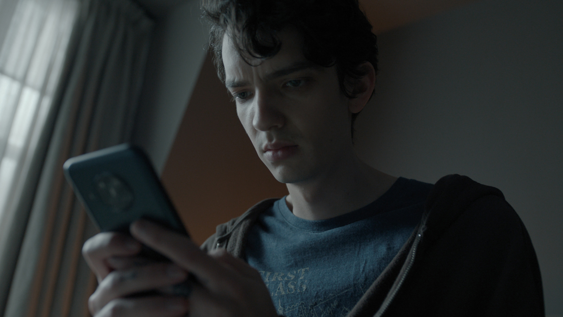 Nicolas looks at his phone in Apple TV Plus psychological thriller series Disclaimer