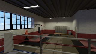 Still from the VR video game The Thrill of the Fight. The image shows the first person view of standing in a boxing ring of an old school gym. In the background you can see a punching bag, a speed bag, some lockers and a wooden bench.