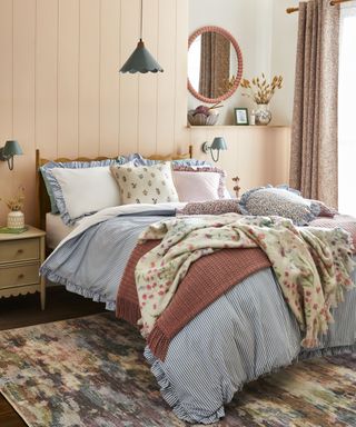 bedroom with vintage floral fabrics decorated in cream, soft pinks and blue