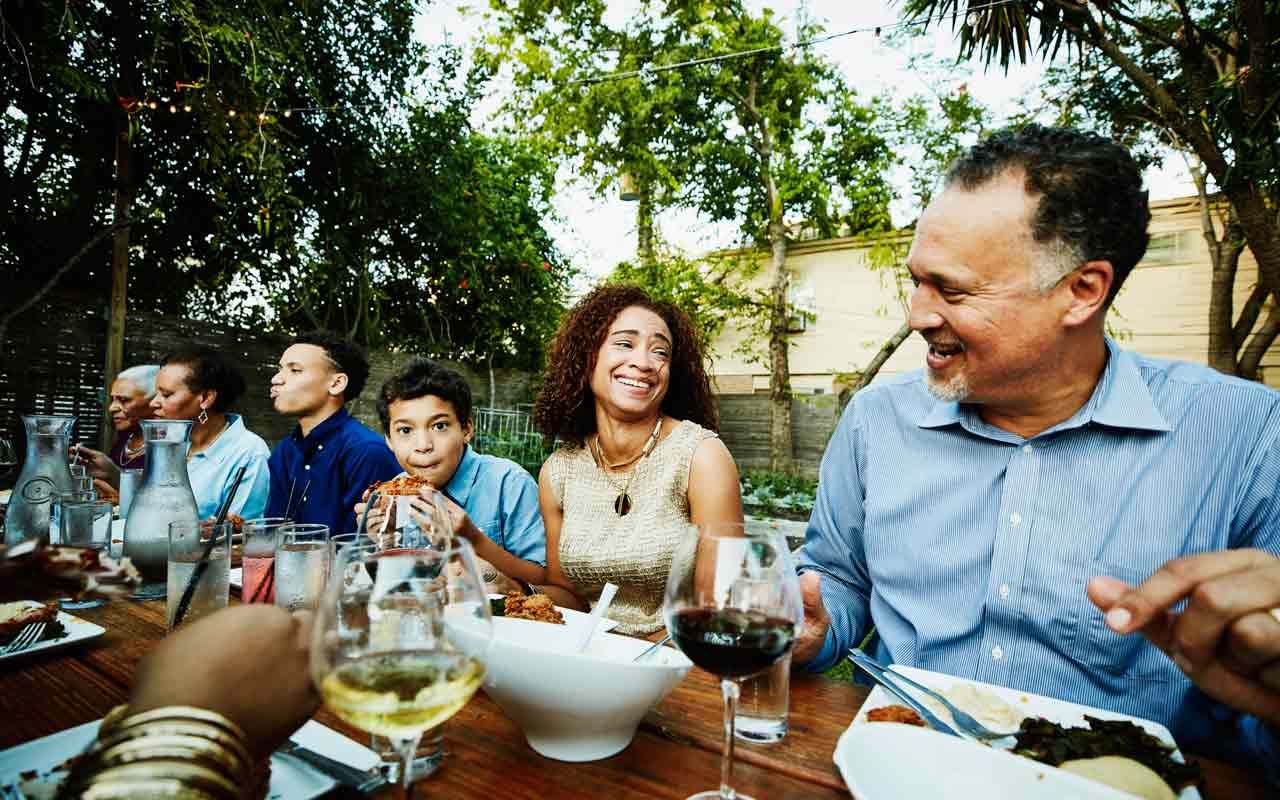 A family enjoying a meal together outside