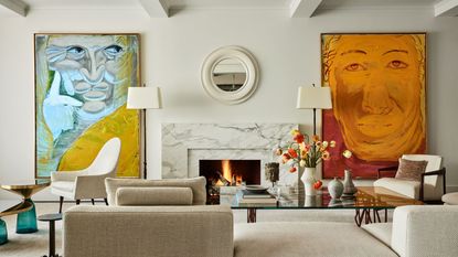 living room with fire lit and two huge paintings and white sofa