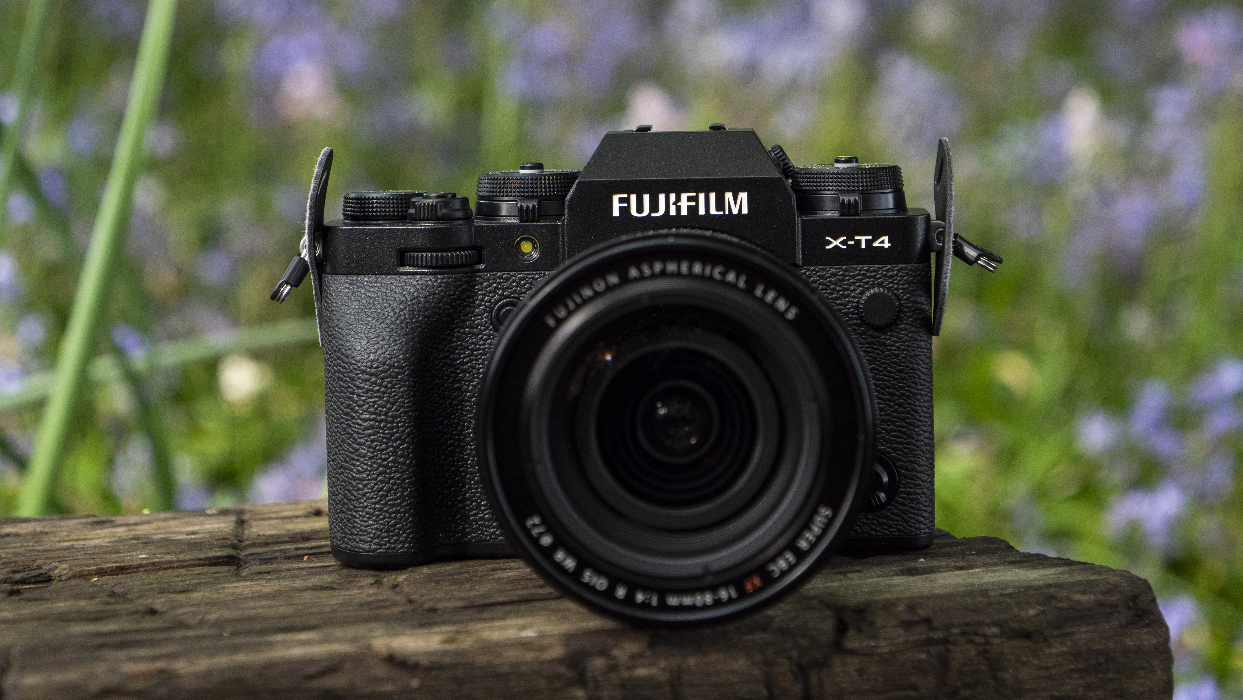 The Fujifilm X-T4 placed on a wooden bench with the new 16-80mm kit lens.