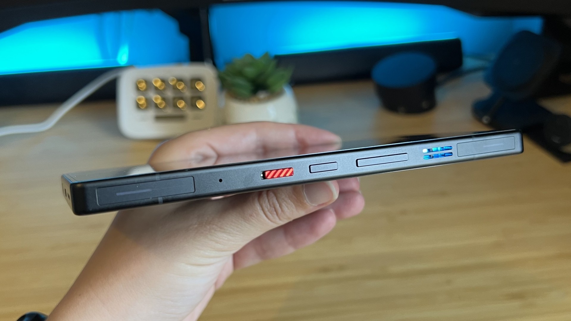 Side of RedMagic 11S Pro showing controls while being held by reviewer