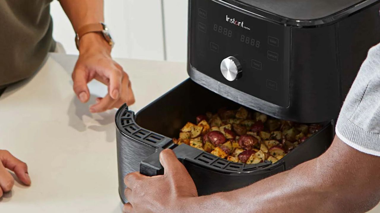 Instant 4-in-1 Air Fryer with the drawer open on a kitchen surface