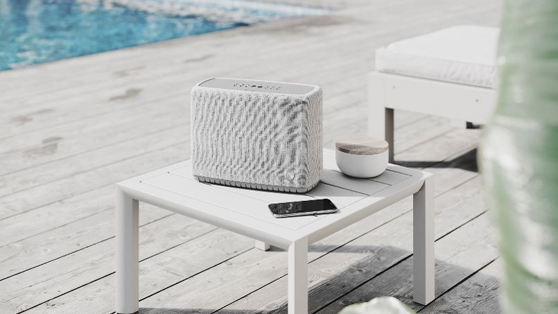 the audio pro a15 bluetooth speaker in a garden