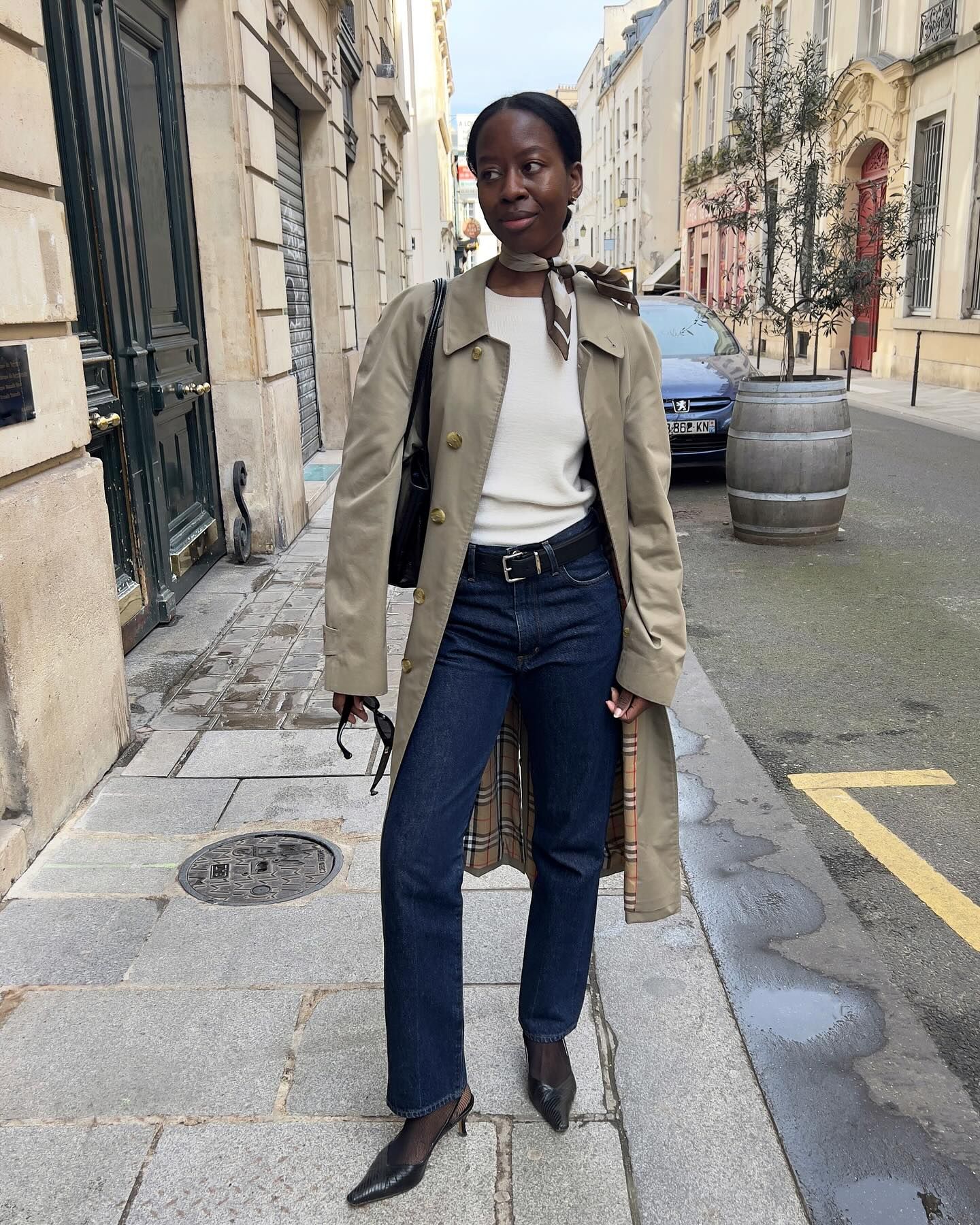 Woman in trench coat, jeans, and pointed-toe slingbacks